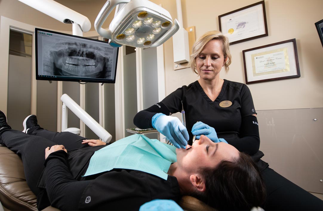 Hygienist performing dental cleaning